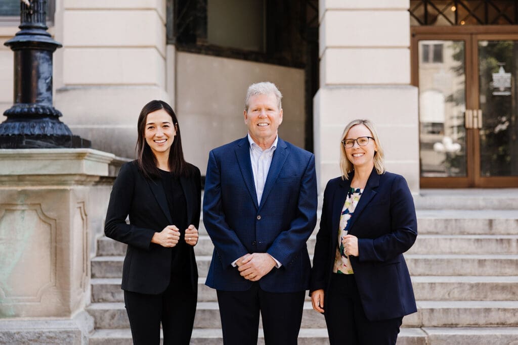 A photo of the Kelly & Castagna team in Downtown Bloomington. From left to right, Josephine Shane, Tim Kelly, Laura Castagna.